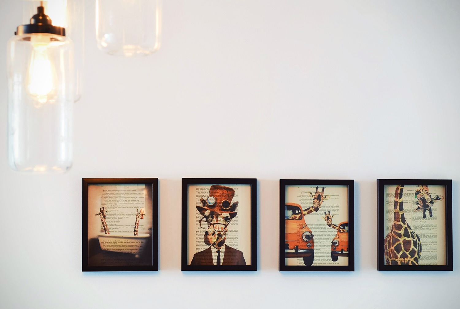 Four framed art prints on a wall