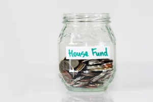 Jar of coins labelled house fund